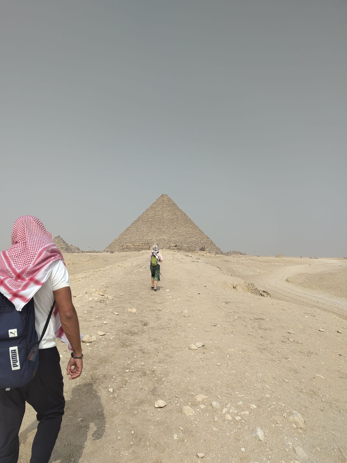 Walking through the desert toward the pyramid